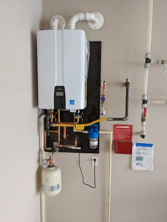 Professional plumber installing copper piping in a Middlesex home